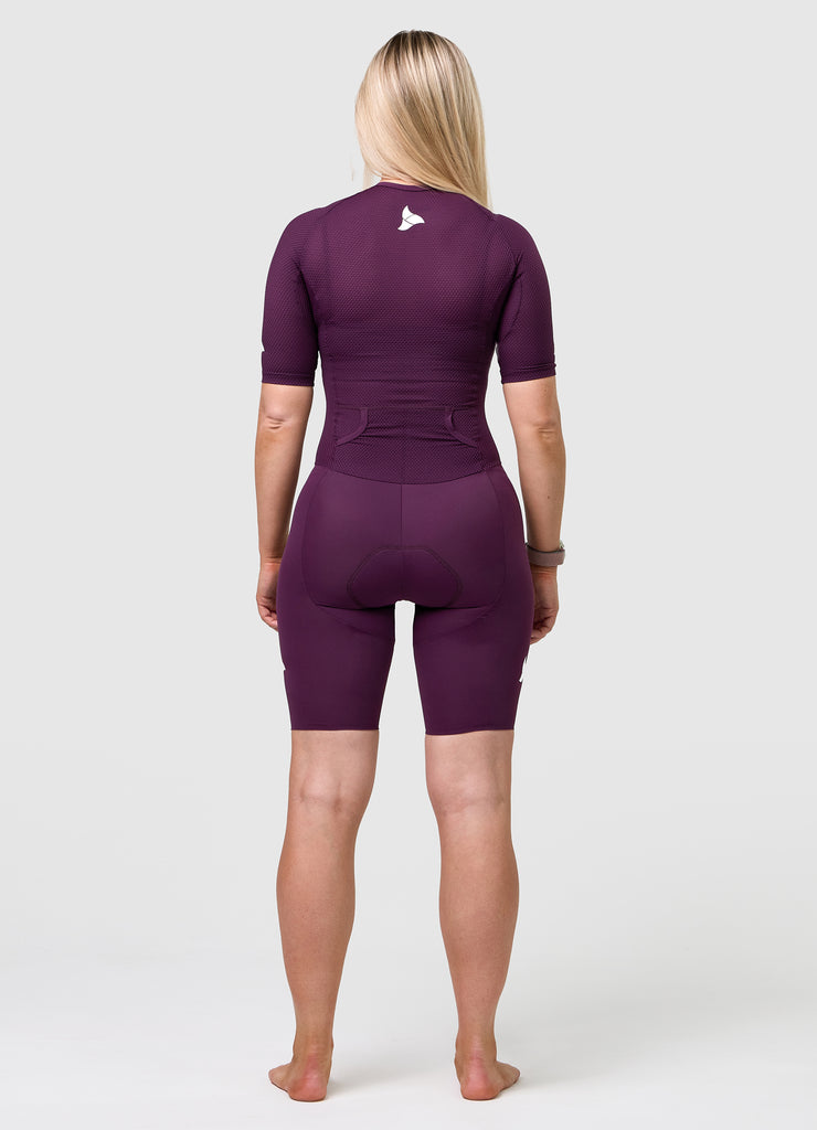 Back view of TRI-FIT VANGUARD tri-suit in plum showing large aerodynamic pockets and shaped rear panel