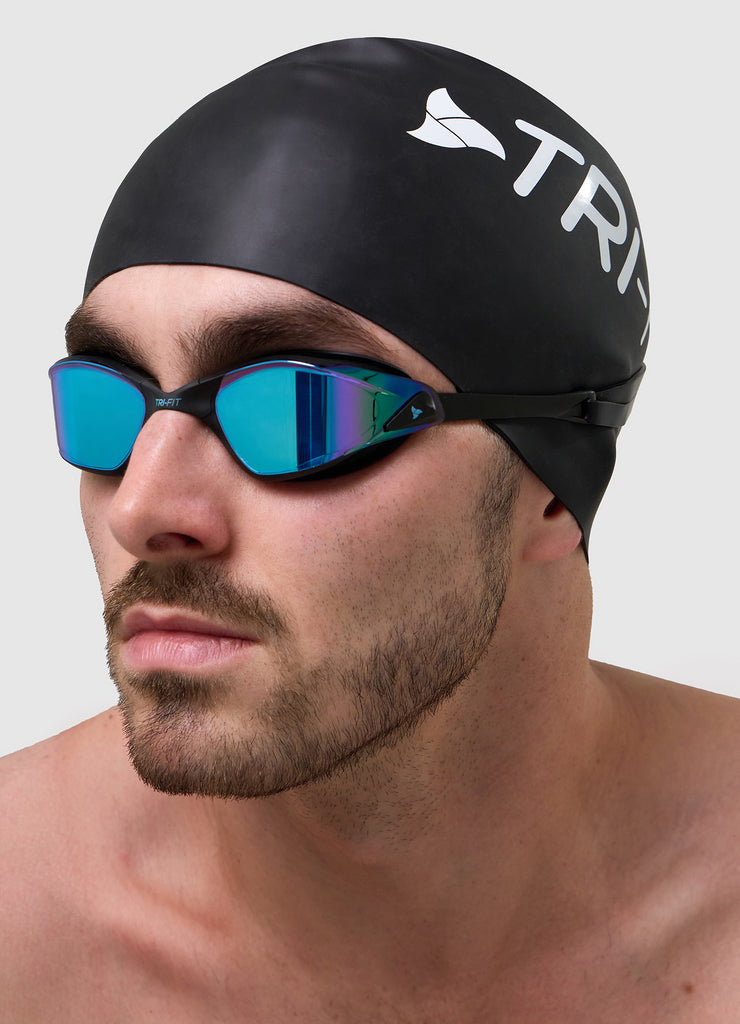 Man wearing TRI-FIT PROPEL Goggles and Black Swim Cap.