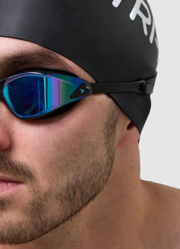Man wearing TRI-FIT PROPEL Goggles and Black Swim Cap.