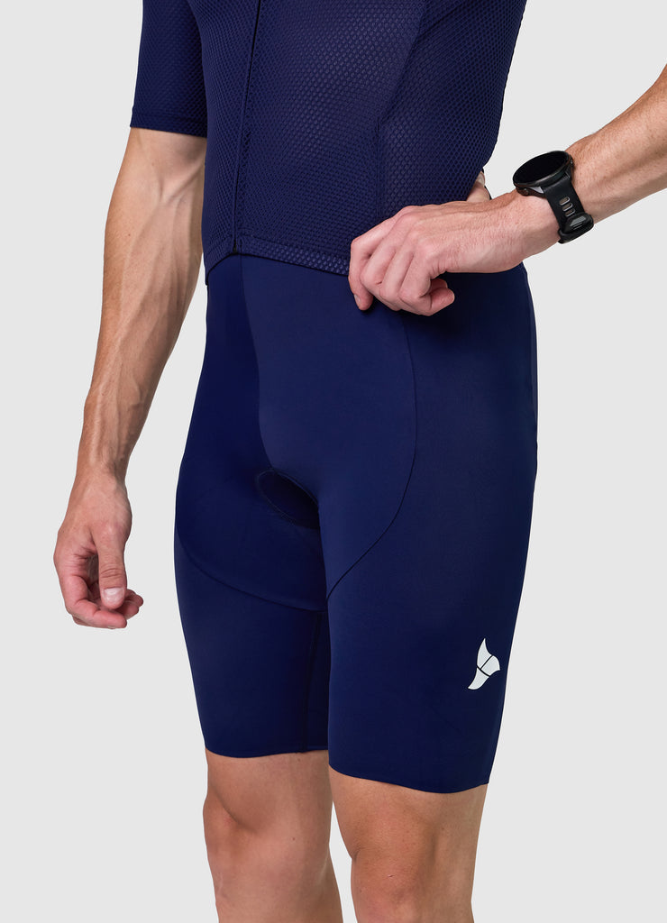 Side profile of men’s VANGUARD tri-suit in navy, showing ergonomic fit and full-body construction