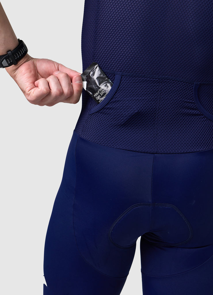 Detail of rear pocket entrance on men’s VANGUARD tri-suit in navy, showing reinforced mesh finish