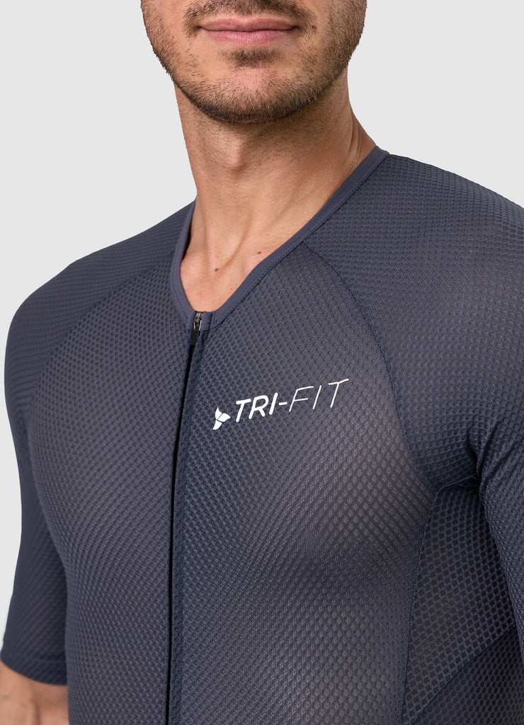 Close-up of TRI-FIT logo printed on chest of men’s VANGUARD tri-suit in grey, with breathable textured mesh fabric