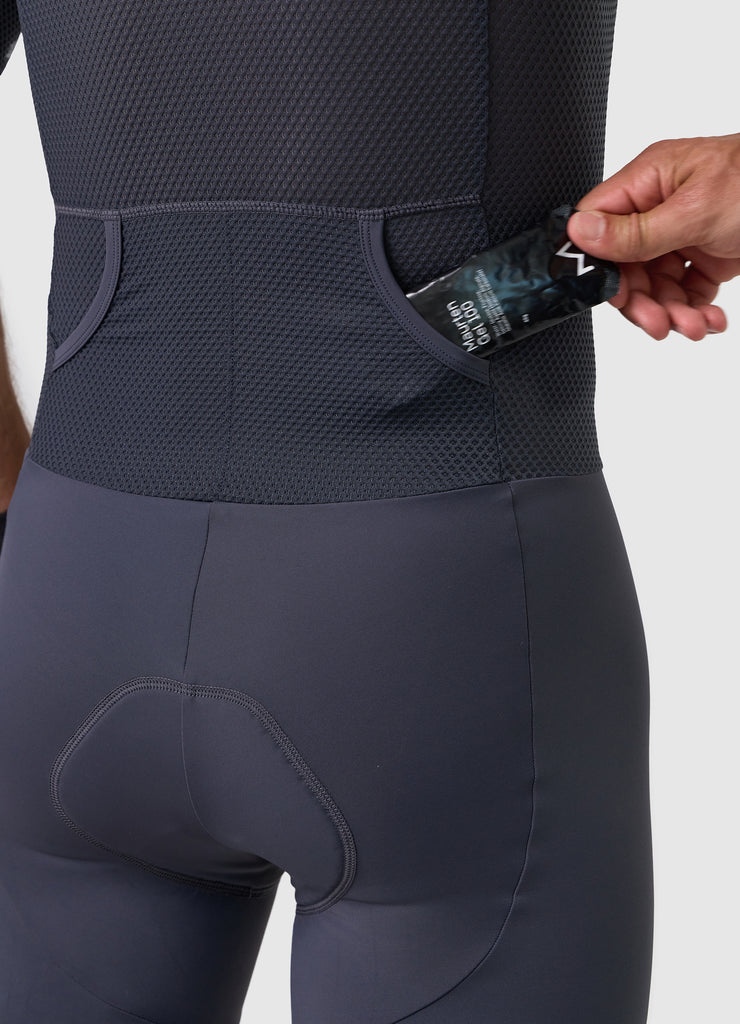 Detail of rear pocket entrance on men’s VANGUARD tri-suit in grey, showing reinforced mesh finish
