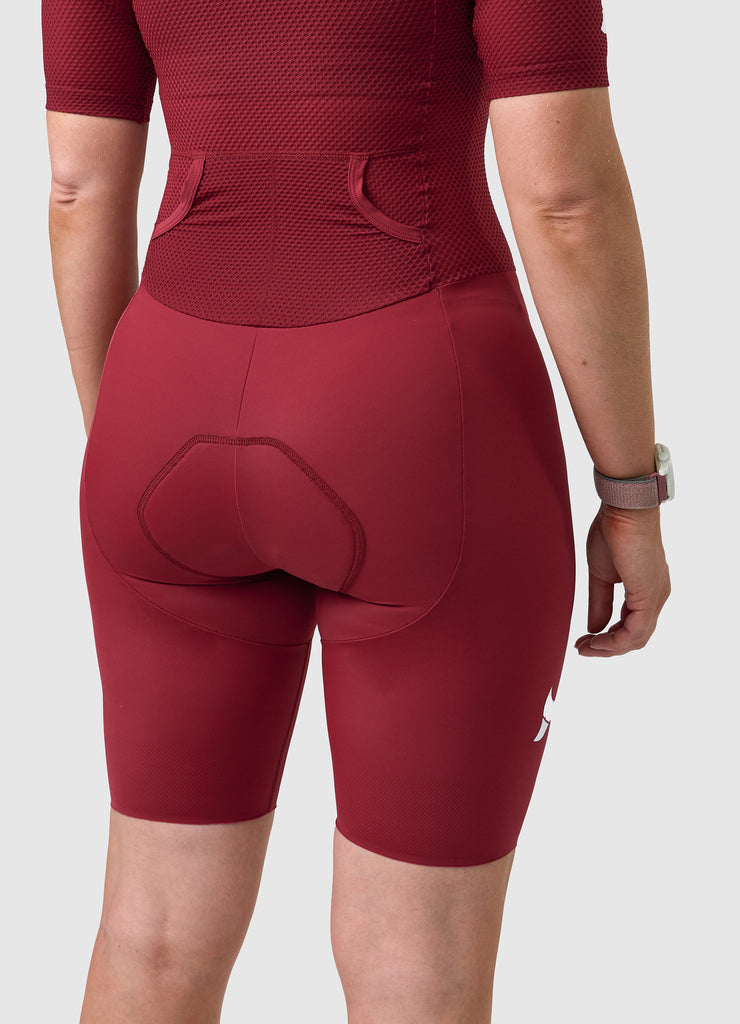 Back view of TRI-FIT VANGUARD tri-suit in wine red showing large aerodynamic pockets and shaped rear panel