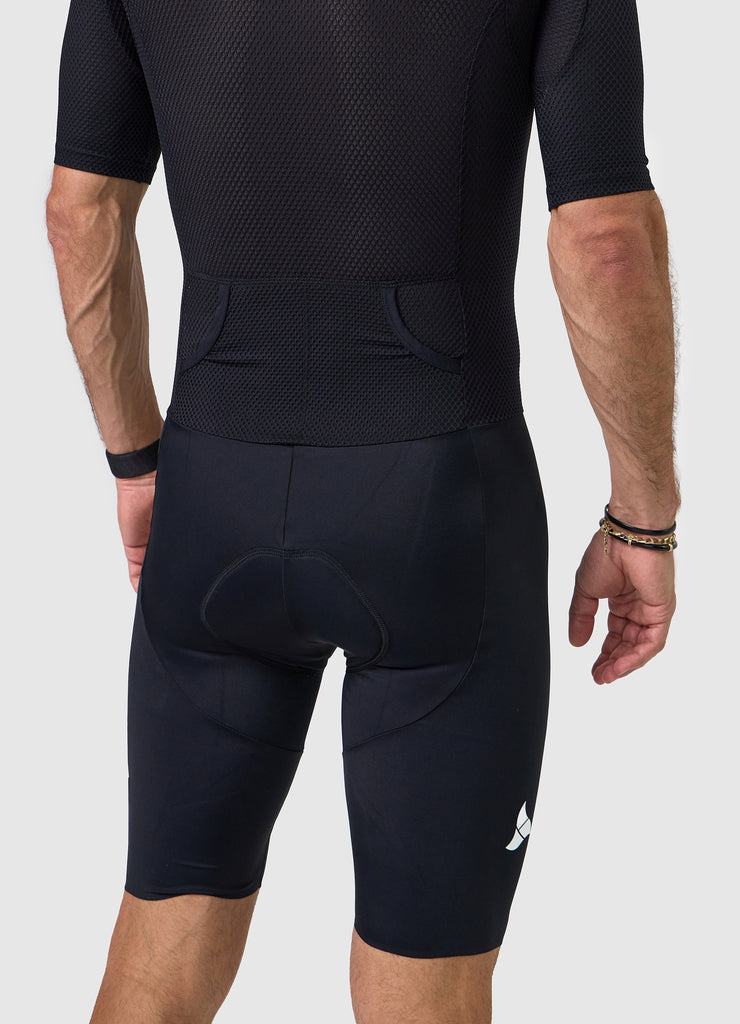 Detail of heat-welded rear pocket entrance on men’s VANGUARD tri-suit in black, showing reinforced mesh finish