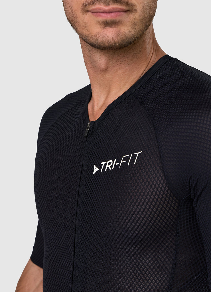 Close-up of TRI-FIT logo printed on chest of men’s VANGUARD tri-suit in black, with breathable textured mesh fabric