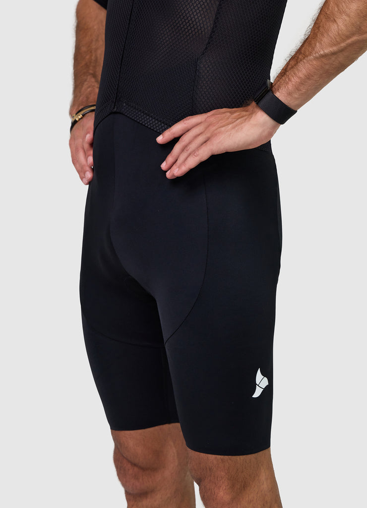 Side profile of men’s VANGUARD tri-suit in black, showing ergonomic fit and full-body construction