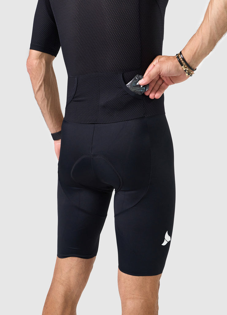 Detail of heat-welded rear pocket entrance on men’s VANGUARD tri-suit in black, showing reinforced mesh finish