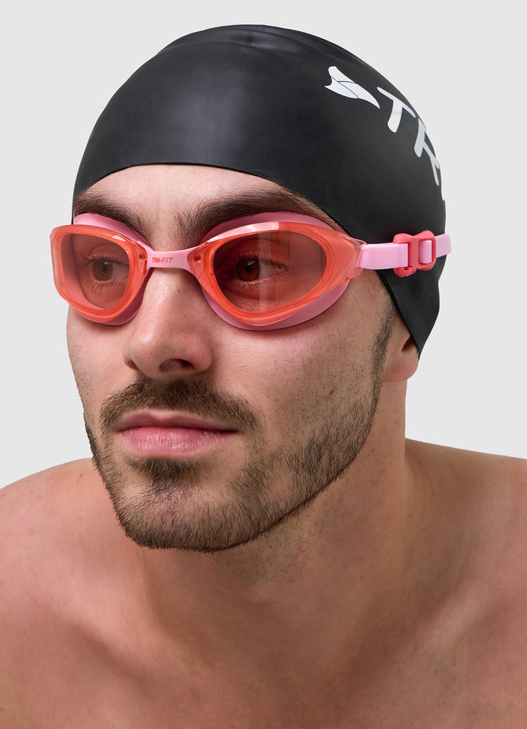 Male wearing TRI-FIT VOLT PINK swimming goggles.