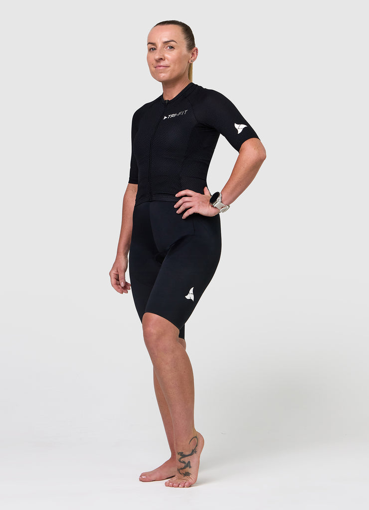 Side angle of TRI-FIT women’s VANGUARD tri-suit in black showing ergonomic fit and panel shaping