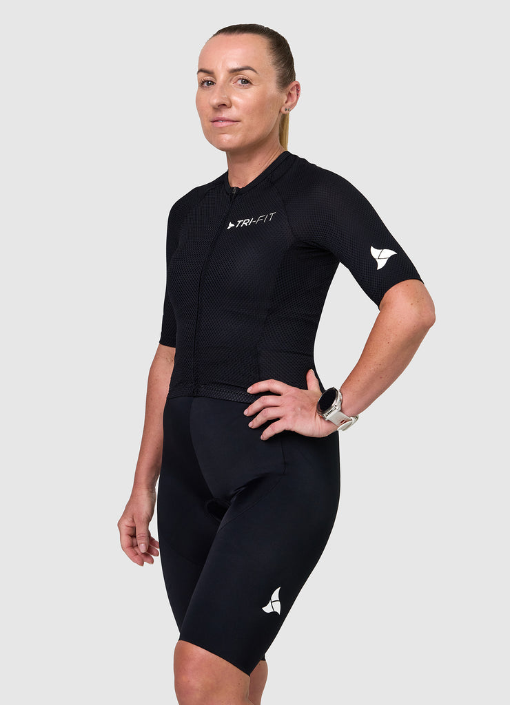 Side angle of TRI-FIT women’s VANGUARD tri-suit in black showing ergonomic fit and panel shaping