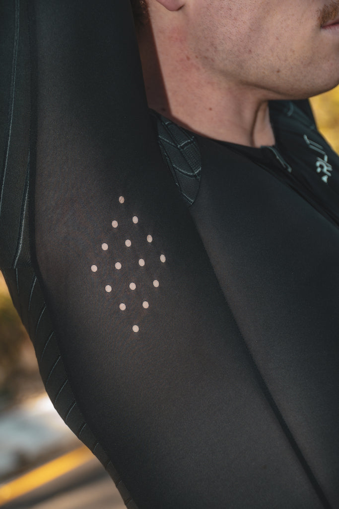 Man wearing TRI-FIT VORTEX tri-suit. Underarm laser cut ventilation.