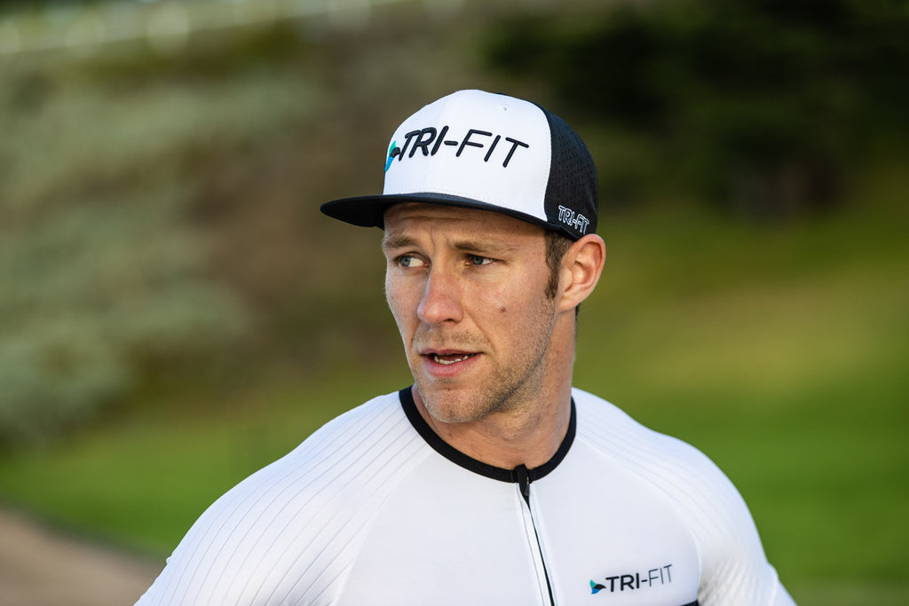 man wearing the award-winning evo tri suit and snapback cap in black and white