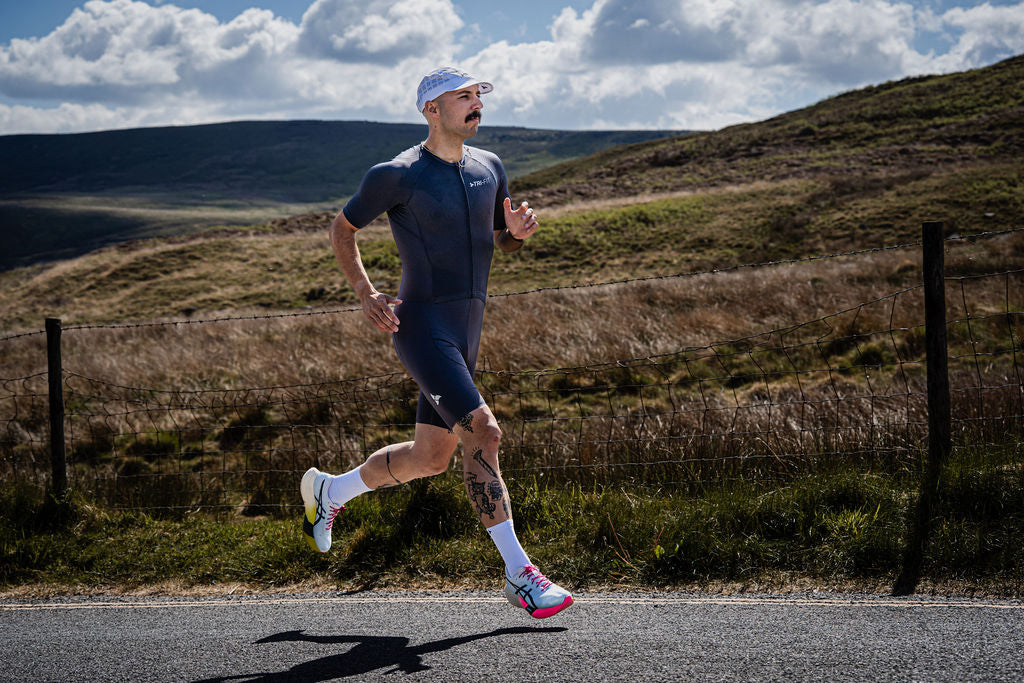 Man running wearing VANGUARD DARK GREY tri-suit. 220 triathlon best on test. 