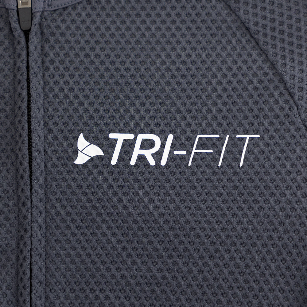 Close-up of TRI-FIT logo printed on chest of men’s VANGUARD tri-suit in grey, with breathable textured mesh fabric