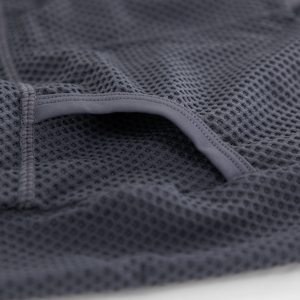 Detail of heat-welded rear pocket entrance on men’s VANGUARD tri-suit in grey, showing reinforced mesh finish