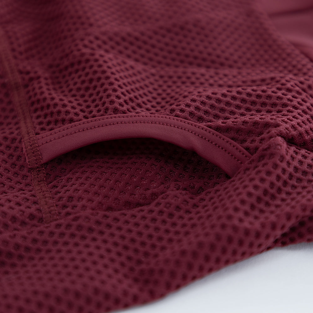 Close-up of rear pocket opening and internal stitching on VANGUARD tri-suit in wine red